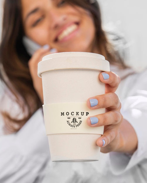Free Woman Holding A Mock-Up Cup Of Coffee Psd