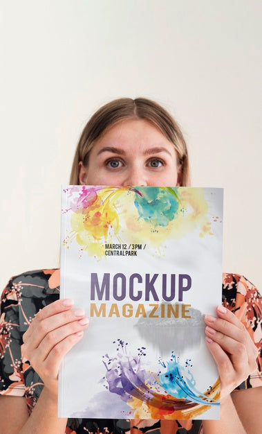 Free Woman Holding A Mock Up Magazine And Looking At Camera Psd