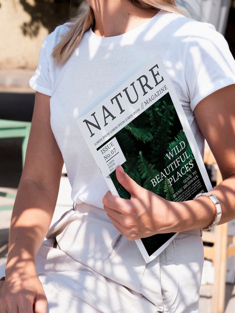 Free Woman Holding A Nature Magazine Mock Up Psd