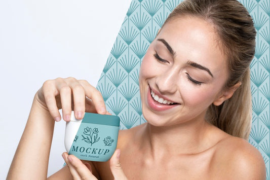Free Woman Holding A Skincare Product Mock-Up Psd