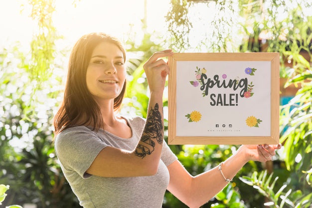 Free Woman Holding Board Mockup For Spring Sale Psd
