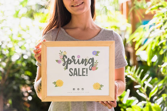 Free Woman Holding Board Mockup For Spring Sale Psd