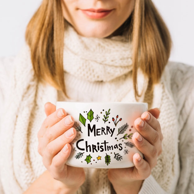 Free Woman Holding Cup Mockup With Christmas Concept Psd