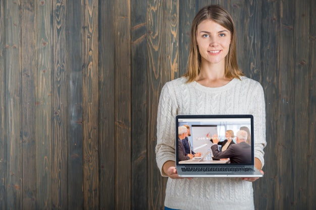 Free Woman Holding Laptop Mockup Psd