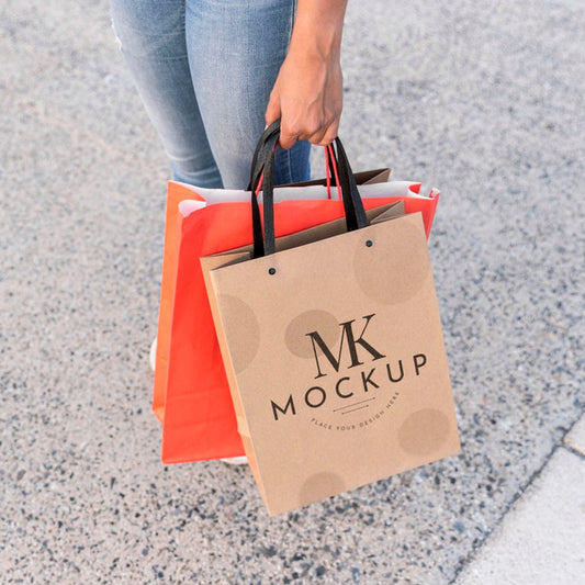 Free Woman Holding Mock-Up Shopping Bags Psd