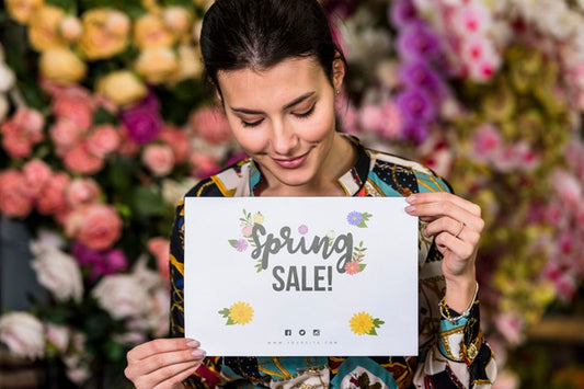 Free Woman Holding Paper Mockup For Spring Sale Psd