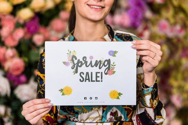 Free Woman Holding Paper Mockup For Spring Sale Psd