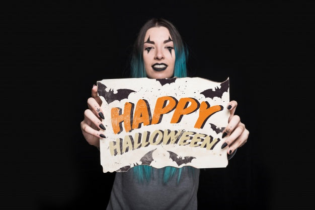 Free Woman Holding Paper With Halloween Lettering Psd