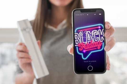 Free Woman Holding Smartphone Mockup With Black Friday Concept Psd