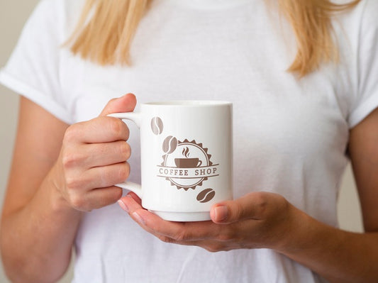Free Woman Holding Up A Coffee Mug Psd