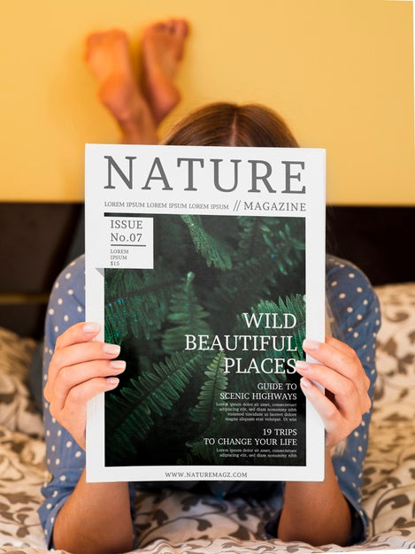 Free Woman In Bed Showing A Nature Magazine Psd