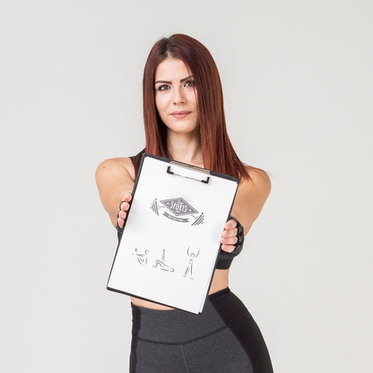 Free Woman In Gym Clothes Holding Notepad Psd