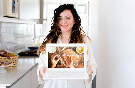 Free Woman In Kitchen Presenting Laptop Mockup Psd