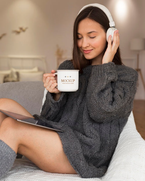 Free Woman Listening To Music On Headphones While Holding A Mug Mock-Up Psd