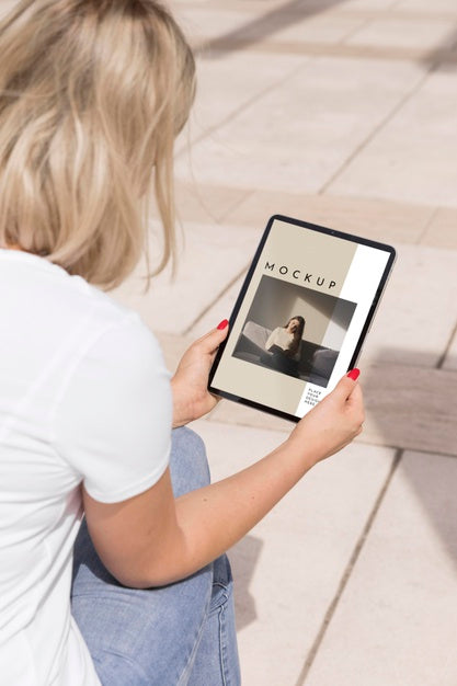 Free Woman On Street Reading Book On Tablet Psd