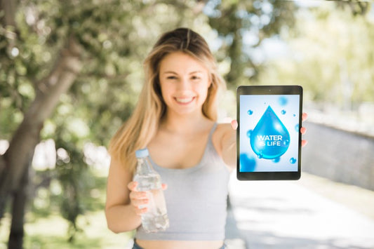 Free Woman Presenting Tablet Mockup With Water Concept Psd