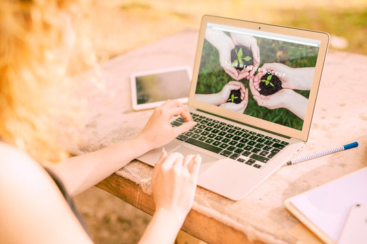 Free Woman Using Laptop Mockup In Nature Psd