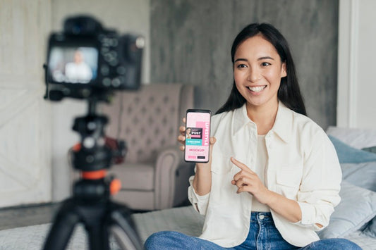 Free Woman Vlogger Holding A Phone Mock-Up Psd
