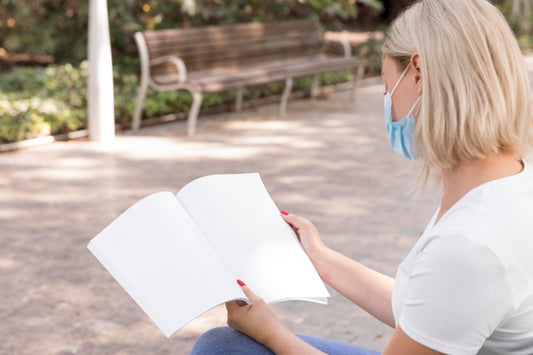 Free Woman With Mask On Street Reading Book Psd