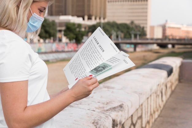 Free Woman With Mask Reading Book On Street Psd