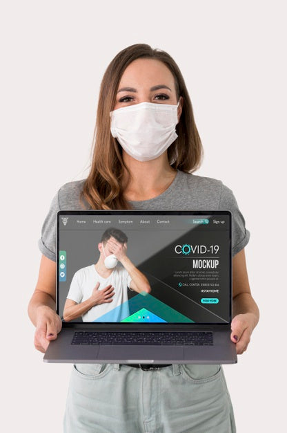 Free Woman With Masks Holding Laptop Psd