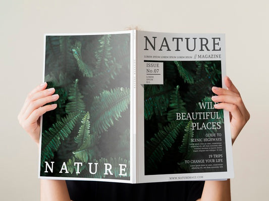 Free Womans Hand Holding A Nature Magazine Mock Up Psd