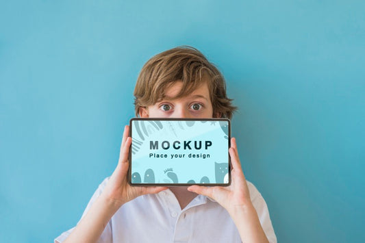 Free Young Boy Holding Phone With Mock-Up Psd