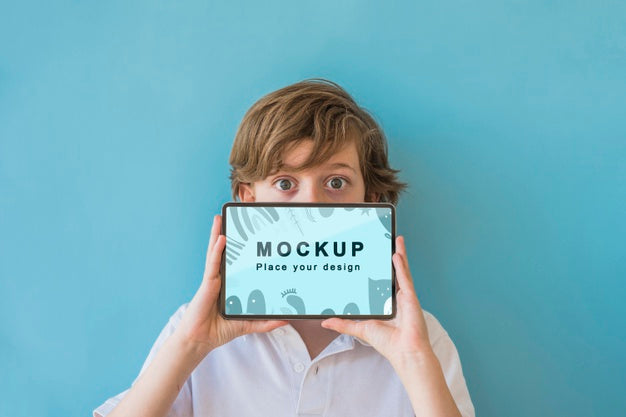 Free Young Boy Holding Phone With Mock-Up Psd