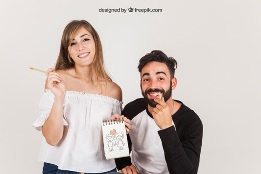 Free Young Couple Holding Notepad Psd