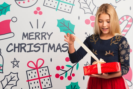 Free Young Girl Unwrapping Gift On Christmas Psd
