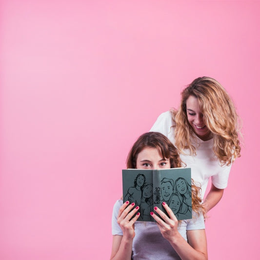 Free Young Girls Holding Book Cover Mockup Psd