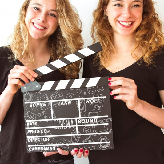 Free Young Girls Holding Clapperboard Mockup Psd