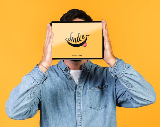 Free Young Man Covering His Face With A Tablet Mock Up Psd