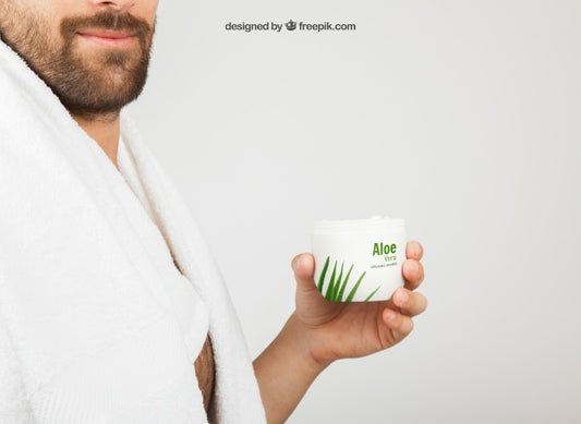 Free Young Man Posing With Aloe Vera Cosmetic Product Psd