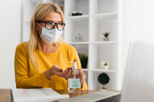 Free Young Woman At Desk With Mask And Disinfectant Mock-Up Psd