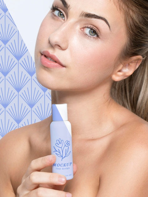Free Young Woman Holding A Skincare Product Mock-Up Psd