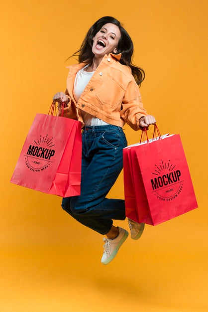 Free Young Woman Jumping And Holding Shopping Bags Mock-Up Psd